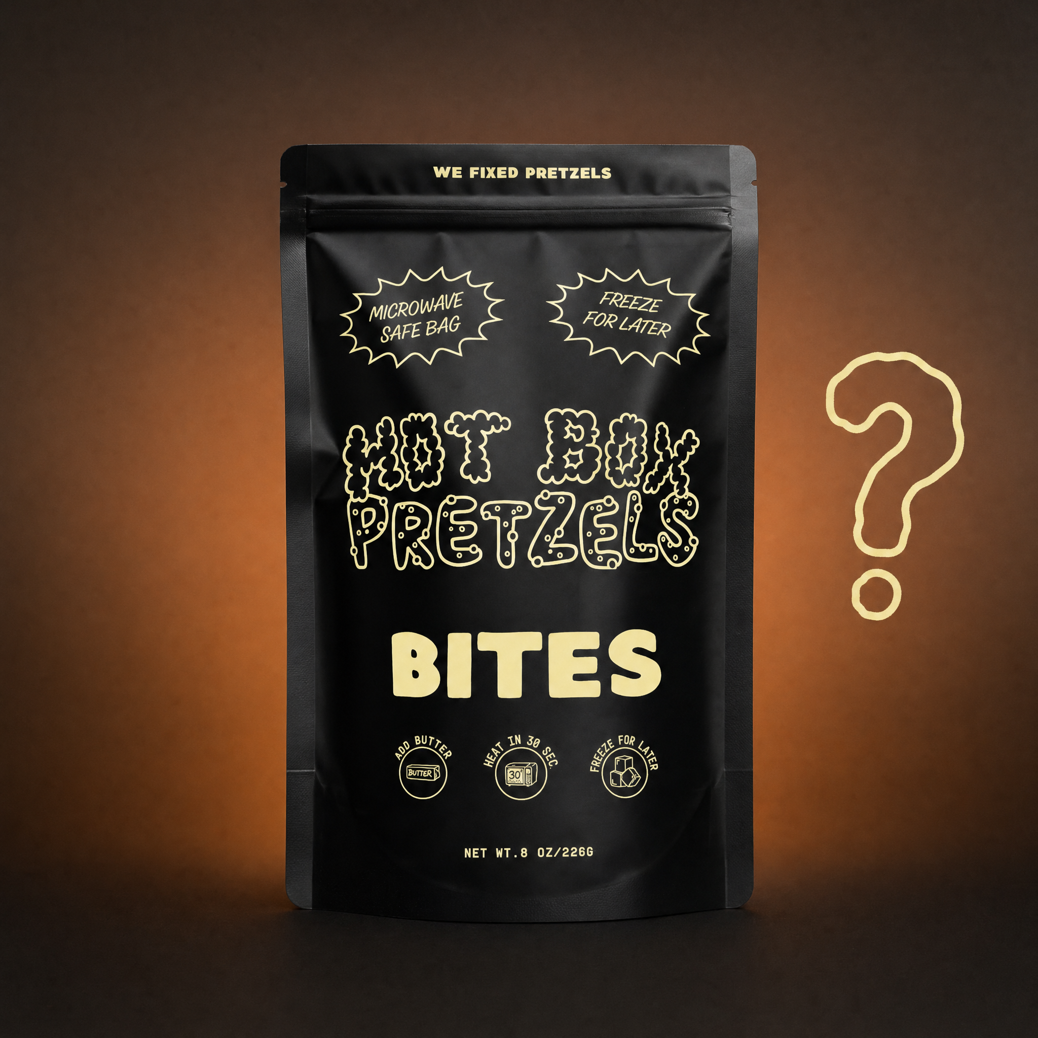 A black Hot Box Pretzels bites bag standing beside a large hand-drawn question mark