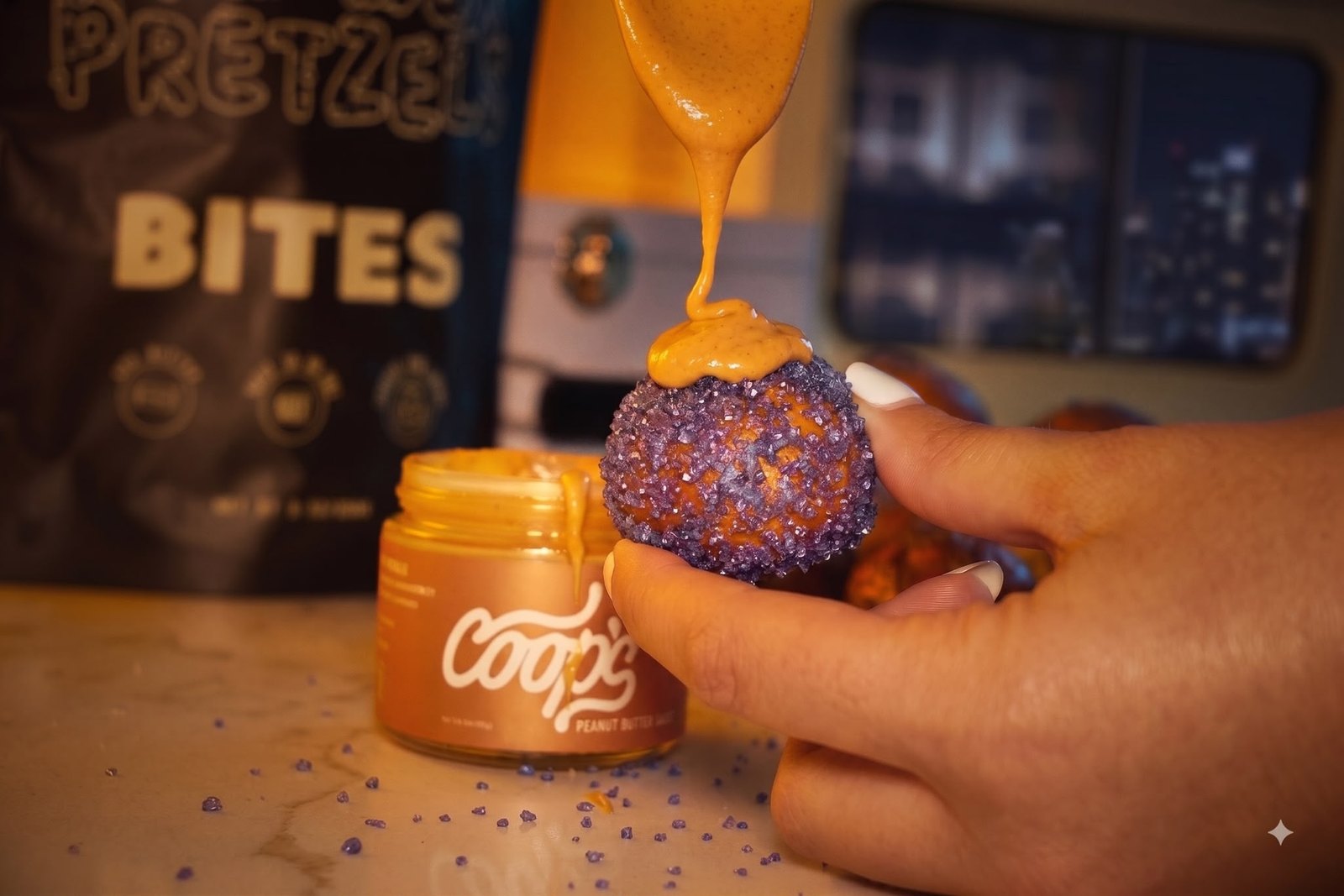 Close-up of a PB&J pretzel bite topped with peanut butter sauce
