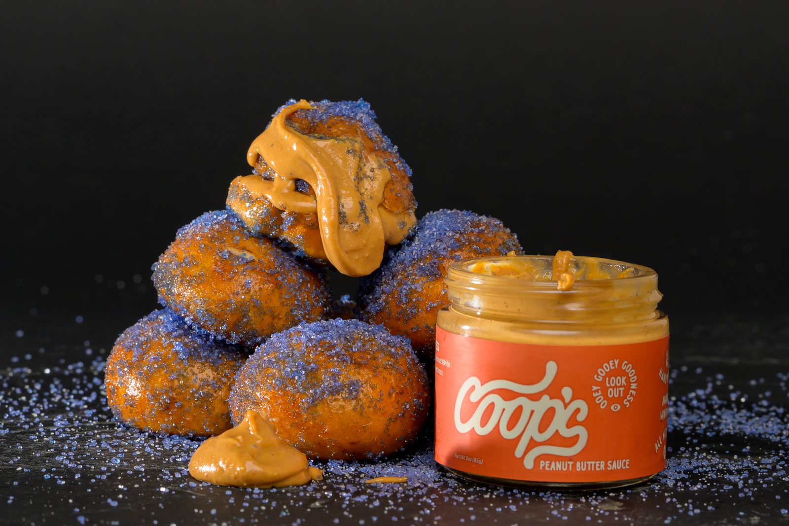 Peanut butter sauce dripping over a pile of pretzel bites